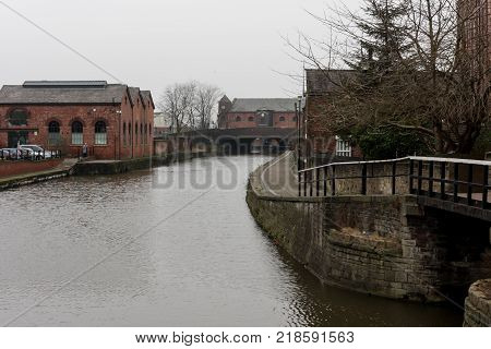 The grey skies over the Leeds Liverpool canal in the centre of Wigan