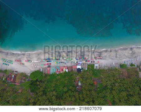 Top Aerial view on recreation area with umbrellas on beach in Bali, Indonesia