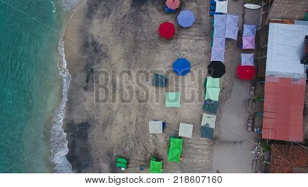 Top Aerial view on recreation area with umbrellas on beach in Bali, Indonesia