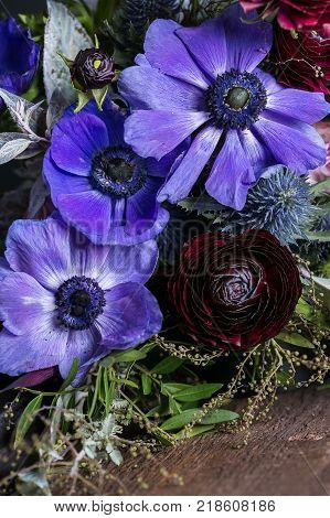 background, wedding, environment concept. close up of bright flowers arranged in the colorfull bouquet for bride, great anemons have lilac and blue shades