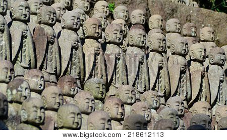 Rows of old buddhist monk traditional small statues in Japan