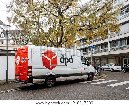 STRASBOURG FRANCE - DEC 4 2017: DPD postal courier van distributing parcels in residential district neighborhood parked on a French street