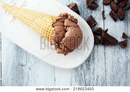 chocolate ice cream scoops with pieces of chocolate and waffle cones
