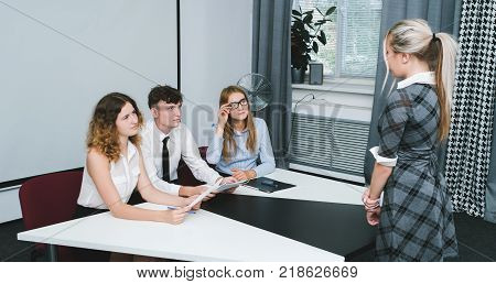 a student girl speak at a scientific conference. unbiased jury. education system
