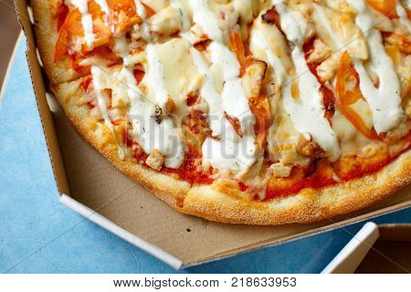 Pizza in a cardboard box against. Space for text. View from above. Pizza delivery. Pizza menu.