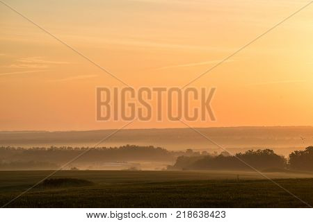 Fantastic landscape of foggy valley in early morning