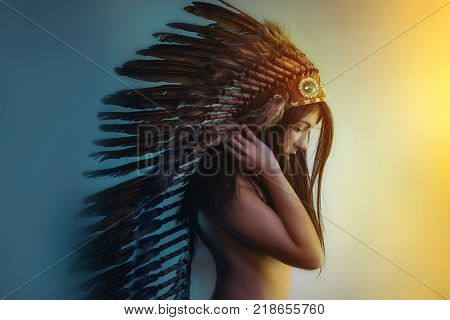 beautiful girl with plume of american indian feathers