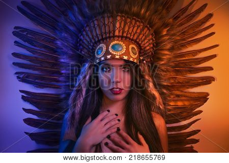 Headdress, beautiful girl with plume of american indian feathers