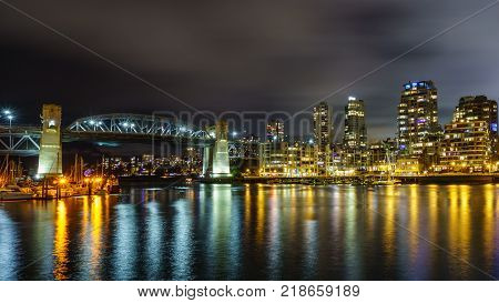 Vancouver Canada - December 15, 2017: Burrard bridge and Vancouver Downtown at night time view from Granville Island