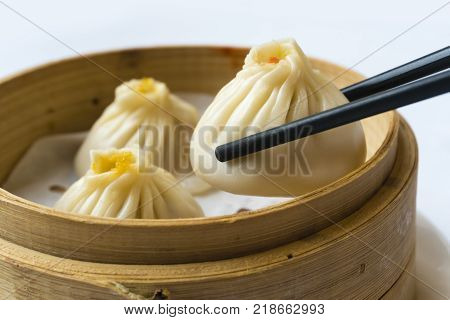 Enjoying traditional Shanghai dumpling, also called xiaolongbao