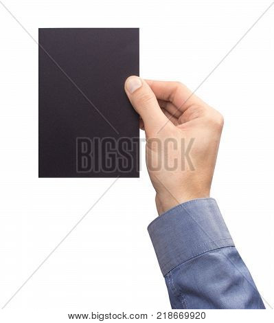 Mockup A6 empty blank black postcard vertically holds the man in his hand in shirt. Isolated on a white background