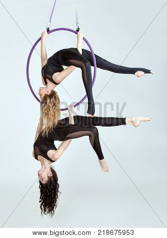 Two women are balancing at the ring they show the show.