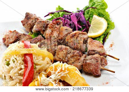 Greek Souvlaki with rice and fried potatoes