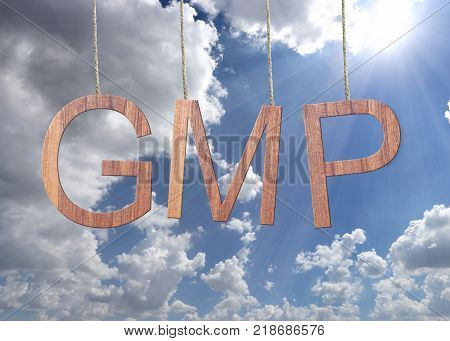 Wooden GMP text Stands for Good Manufacturing Practice hanging on rope on blue sky background.
