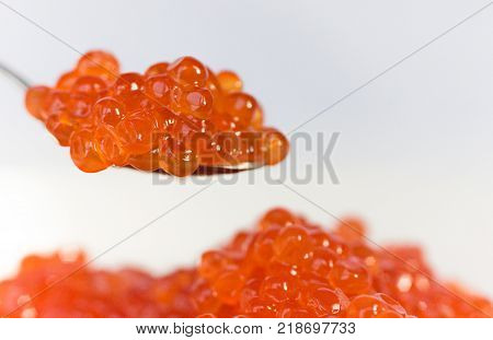 The Abundance of Red Caviar Isolated on White Background