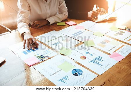Young Business Woman Holding A Pen Pointing The Graph And Partnership To Analyze The Marketing Plan 