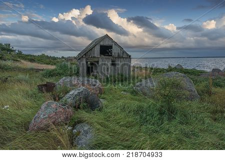 Abandoned houses in the Baltic Sea. Shore, nature and ruins facilities architecture concept. Mohni, small island in Estonia, Europe.