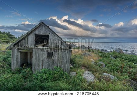 Abandoned houses in the Baltic Sea. Shore nature and ruins facilities architecture concept. Mohni small island in Estonia Europe.