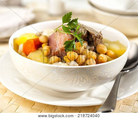 Cocido is a traditional Spanish stew prepared with chickpeas meat and sausages.