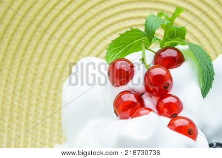 Delicious ice-cream with red currant. Ripe red currant and vanilla ice cream for healthy refreshing cold summer dessert
