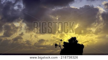 Dramatic sunrise over the Adriatic Sea with Kamen Brela - Tiny famous island in Brela, Makarska Riviera, Croatia