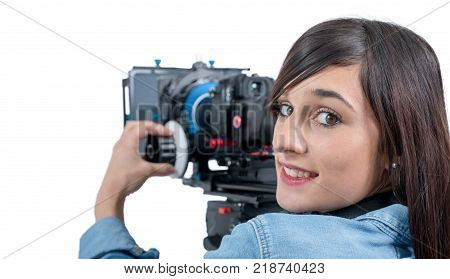 beautiful young woman with professional DSLR video camera on white