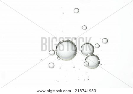 Large and clear water bubbles floats over a white background