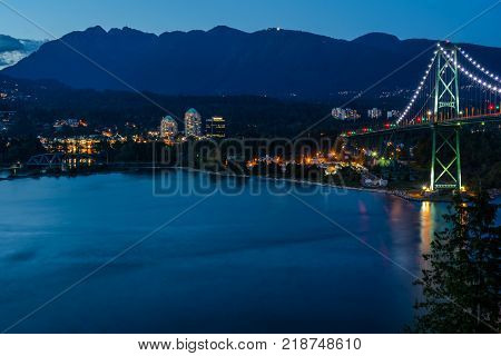 Lions Gate Bridge Sunset and evening of the beautiful town on Pacific Ocean in Vancouver Canada.
