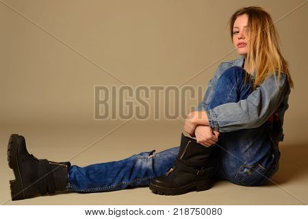 Teenage Girl Sitting On The Floor Showing The Tongue