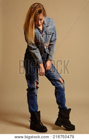 Teenage Girl Sitting On The Floor Showing The Tongue