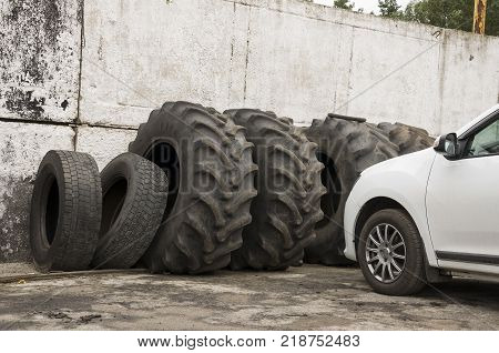 Service station for cars. Old tires on the yard