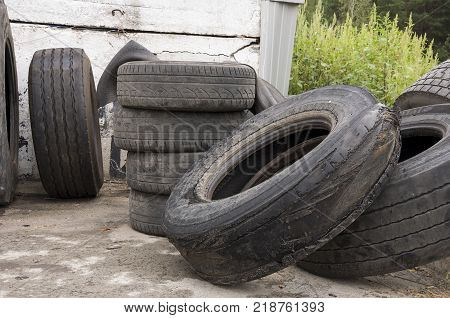 Service station for cars. Old tires on the yard