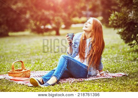 girl sitting in the sunny park. picnik