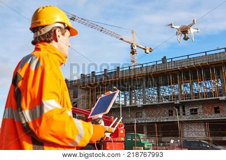 Drone operated by construction worker on building site