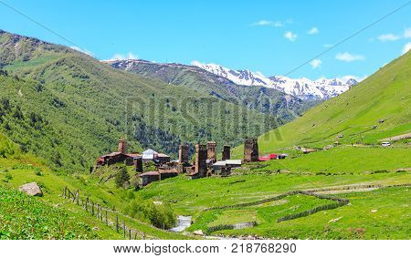 View of the Ushguli village at the foot of Mt. Shkhara. Picturesque and gorgeous scene. Rock tower in Ushguli - the highest inhabited village in Europe