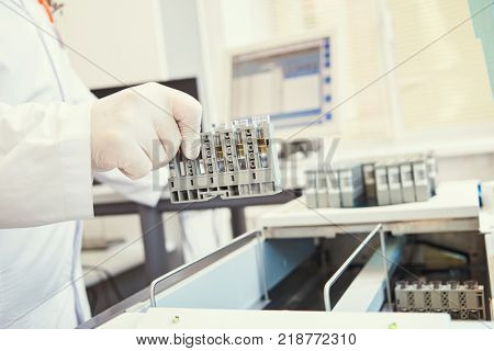 Dope test. biochemical medical laboratory. Hand with test near analyzer