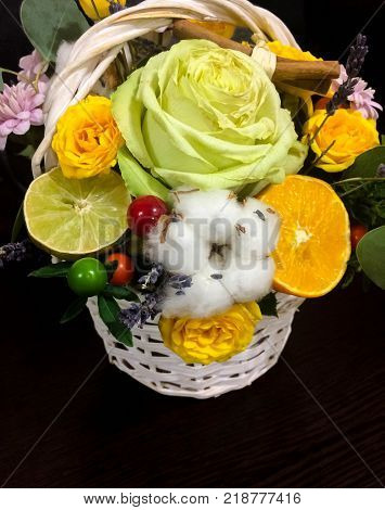 Beautiful composition of flowers and fruits. Bouquet on a dark background