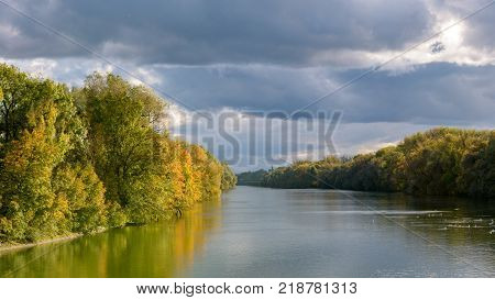 Sunrise over mountains and lake with canoeist
