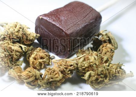 Cannabis Around Chocolate Sucker Representing Marijuana Edibles