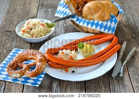 German food for the beer garden: Hot Debreziner sausages  with spicy mustard, sauerkraut and fresh pretzels