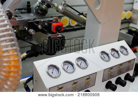 Closeup view of the automatic edge banding machine. Selective focus.