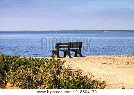 Secluded bench overlooking a large wetland marsh in the Ding Darling National Refuge on Sanibel Island Florida