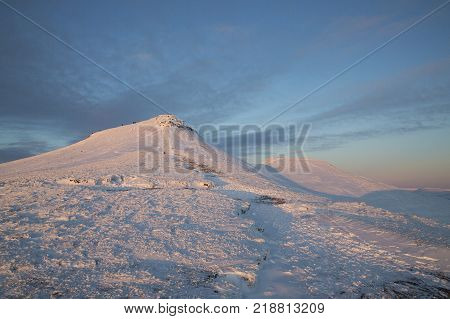 Winter snow scene at sunset on Pen y Fan mountain in the Brecon Beacons National Park, UK