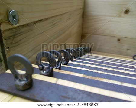 rings march down in the wooden room. screw screwed in wood