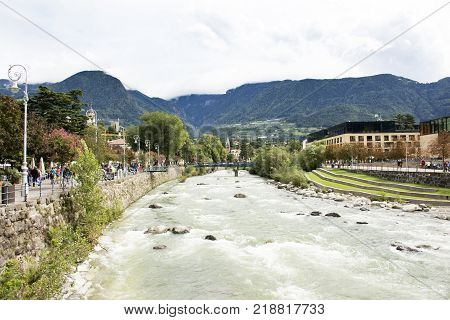 View cityscape and landscape with Italian people and foreigner travelers walking on the bridge crossover passer river at Meran city on September 2 2017 in Merano Italy