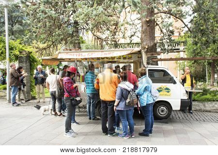 Italian people and foreigner travelers buying food Burger or Hot Dog Buns Recipe Italian style from food truck at Meran city on September 2 2017 in Merano Italy
