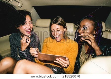 Diverse women in a backseat of a cab