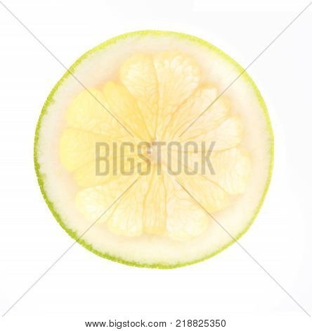Backlit pomelo fruit slice isolated on white background. Closeup texture of cut juicy tropical fruit, top view
