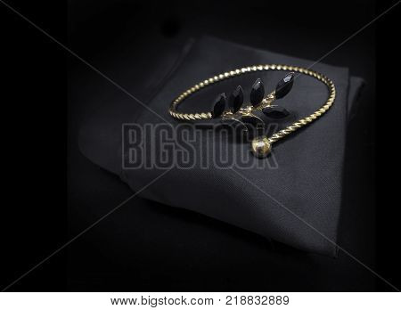 Jewellery black diamonds gold bracelet isolated on black cloth background