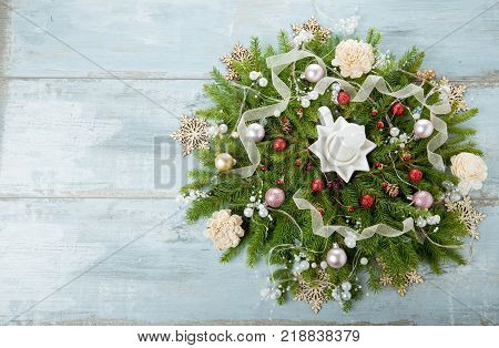 Decorated Advent wreath with white candles on blue wooden background useful as christmas decoration